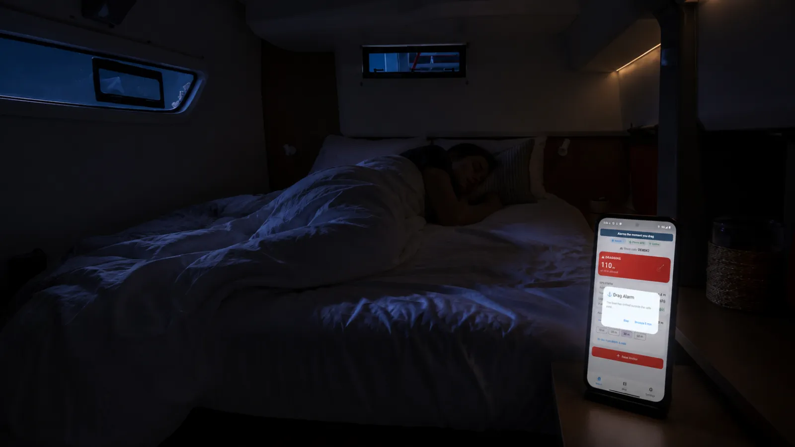 Phone sounding the Anchor Alarm Pro drag alarm at night in a boat cabin while the crew sleeps
